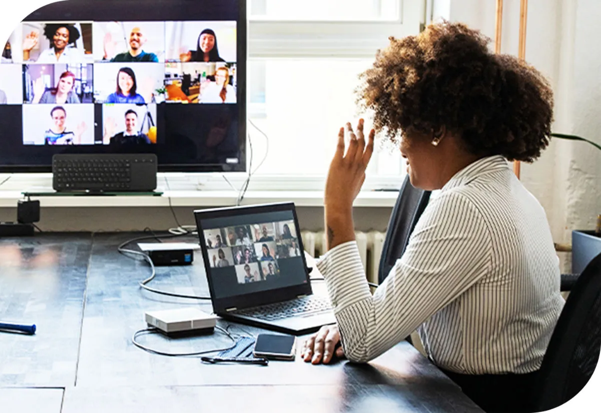Lady in an office communicating with her team remotely